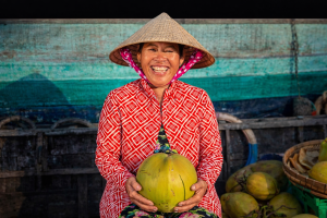 Vietnamese woman selling coconuts on floating market, Mekong River Delta-2