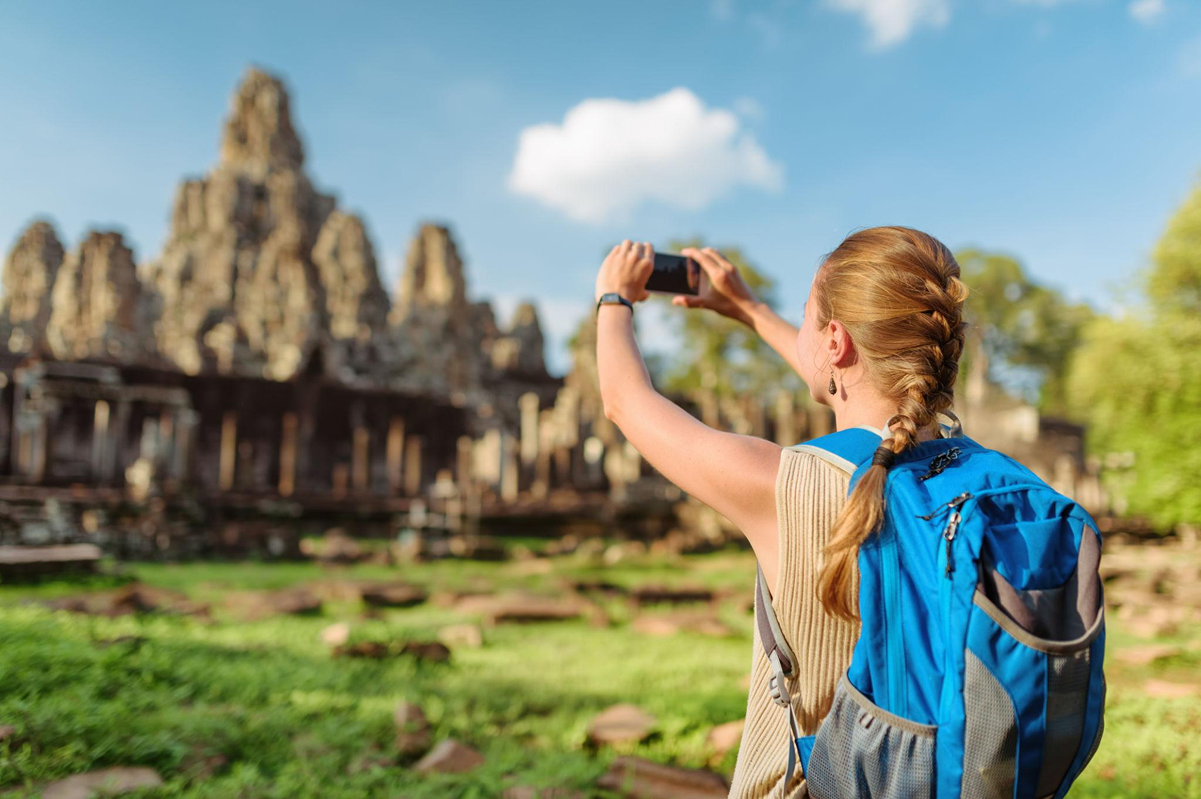 Tourist taking photos from different angles of the temple