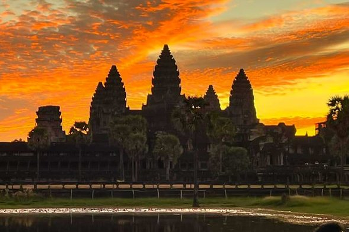 Angkor Wat temple at sunset with dramatic golden light