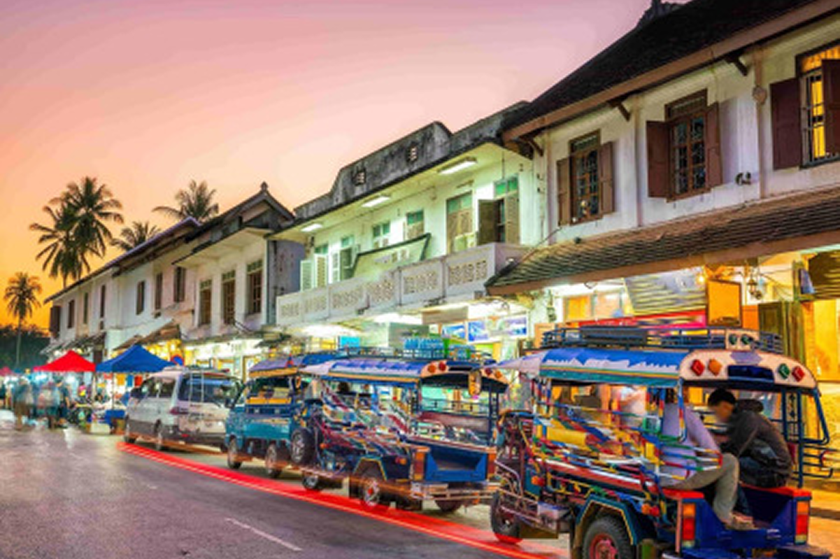 Busy Southeast Asian city street with colorful tuk tuks