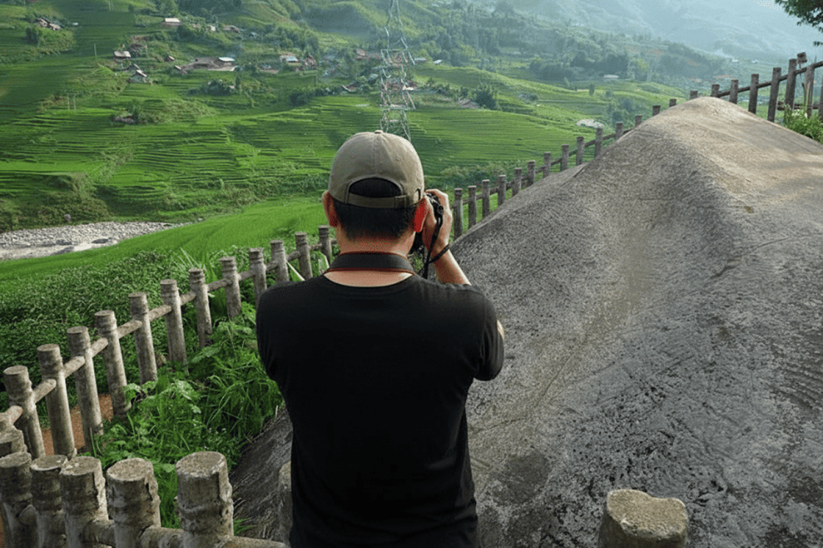 visitors exploring sapa ancient rock field and surrounding landscape local ethnic culture near sapa ancient rock field in Muong Hoa Valley