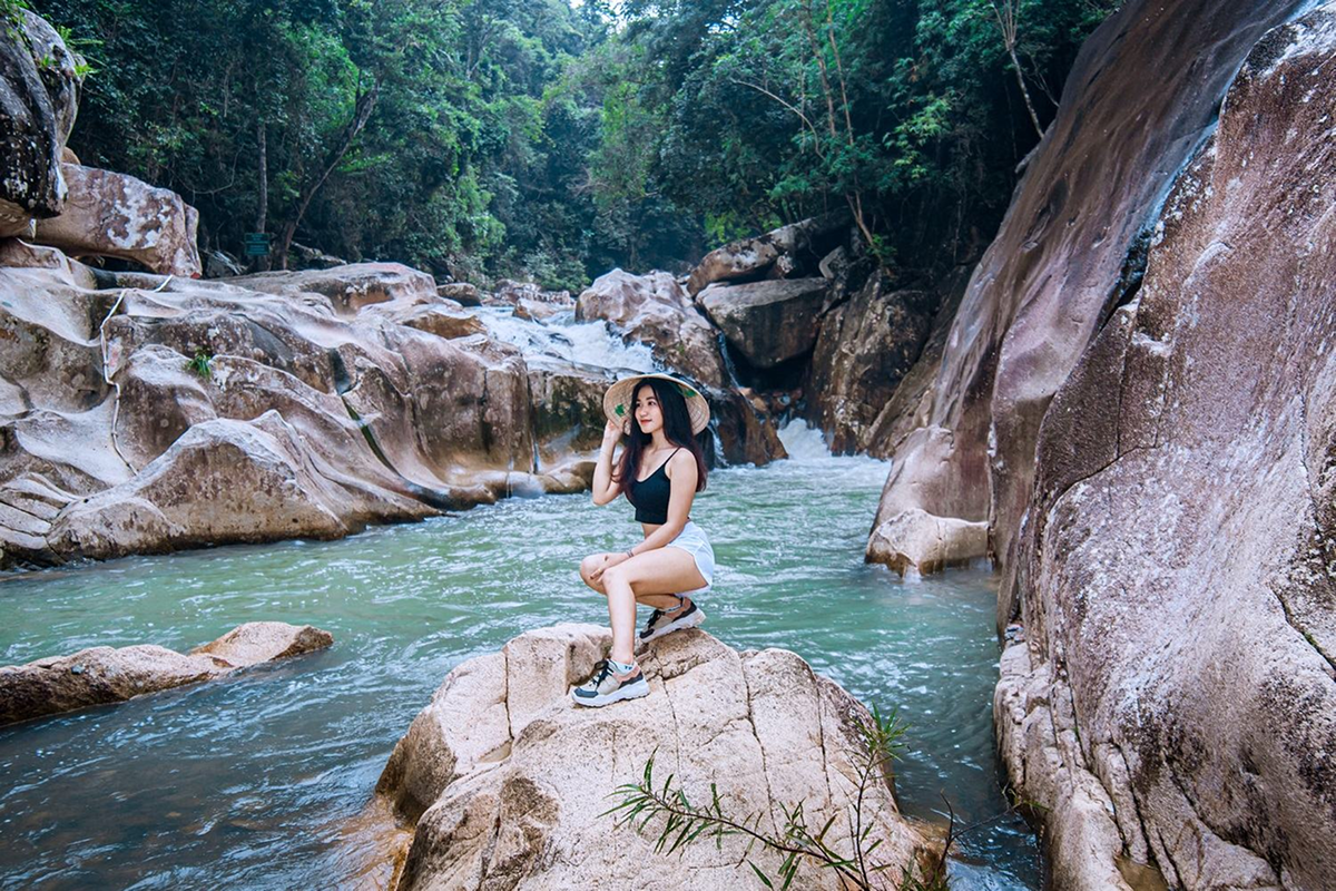 Scenic photo spot with waterfall, rocks, and tropical jungle