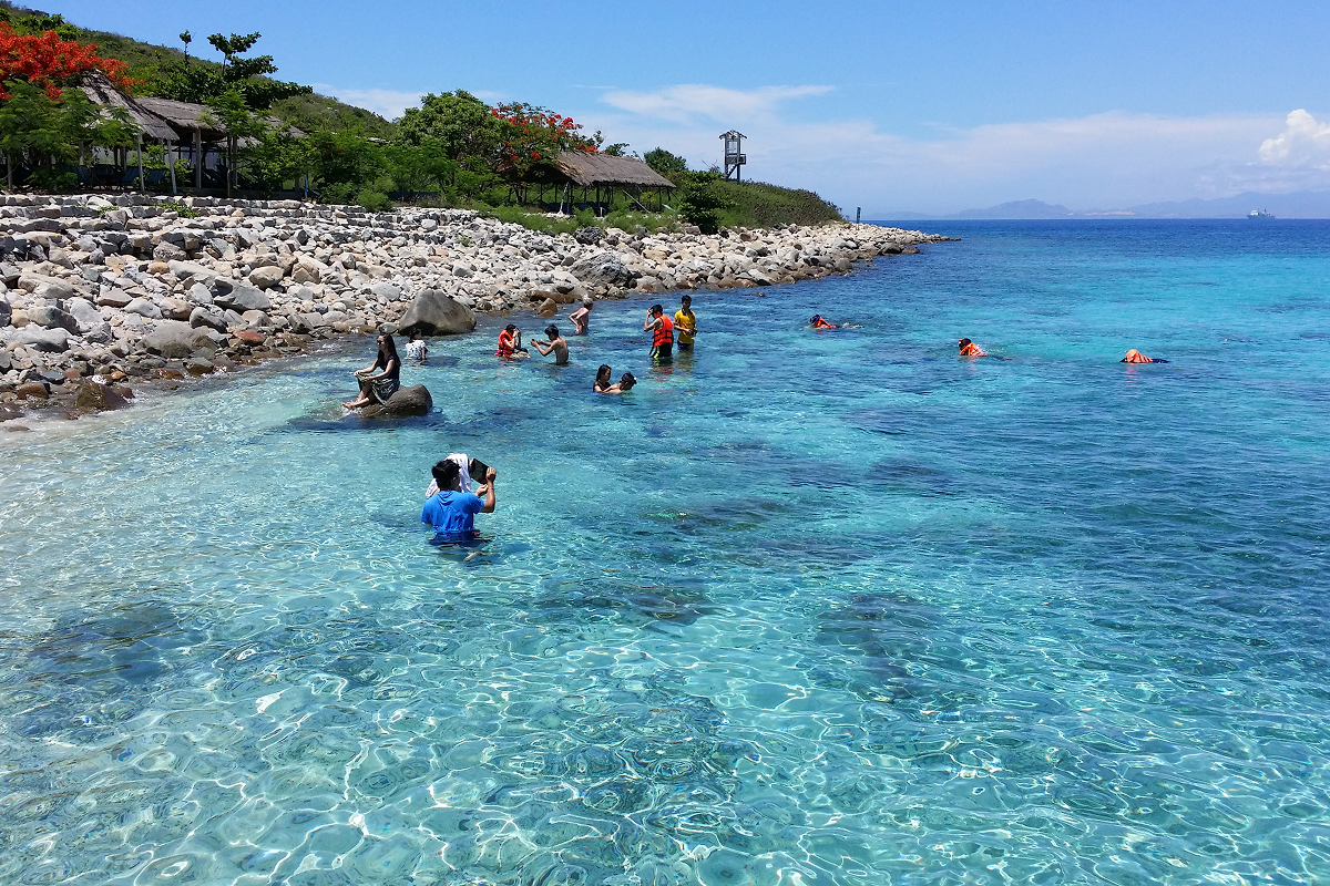Snorkeler wearing mask and fins in clear water following safety tips in Nha Trang